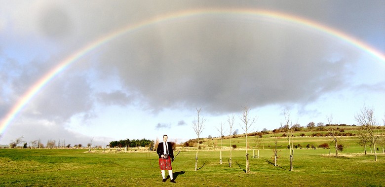 Andrew Macgregor-Boyle at his drive-in beneath the umbrella of a magnificent rainbow