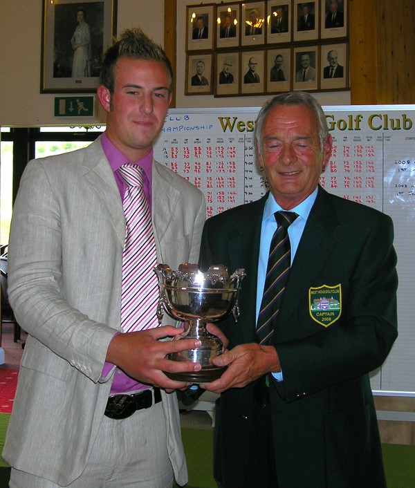 Club Captain Dennis Baker presents Tom Coulson with the Club Championship Trophy