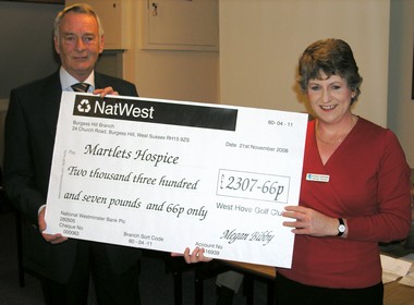 Outgoing Club Captain Dennis Baker presents a cheque to Antonia Shepherd from The Martlets Hospice, Hove